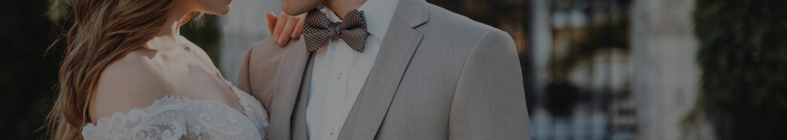 Сouple wearing a white gown and a gray suit